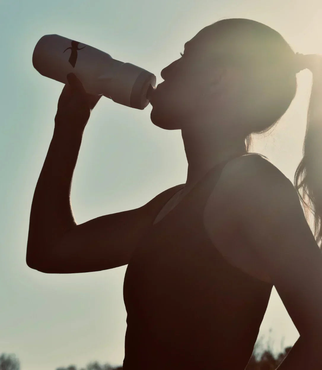 Athlete drinking from Xendurance water bottle