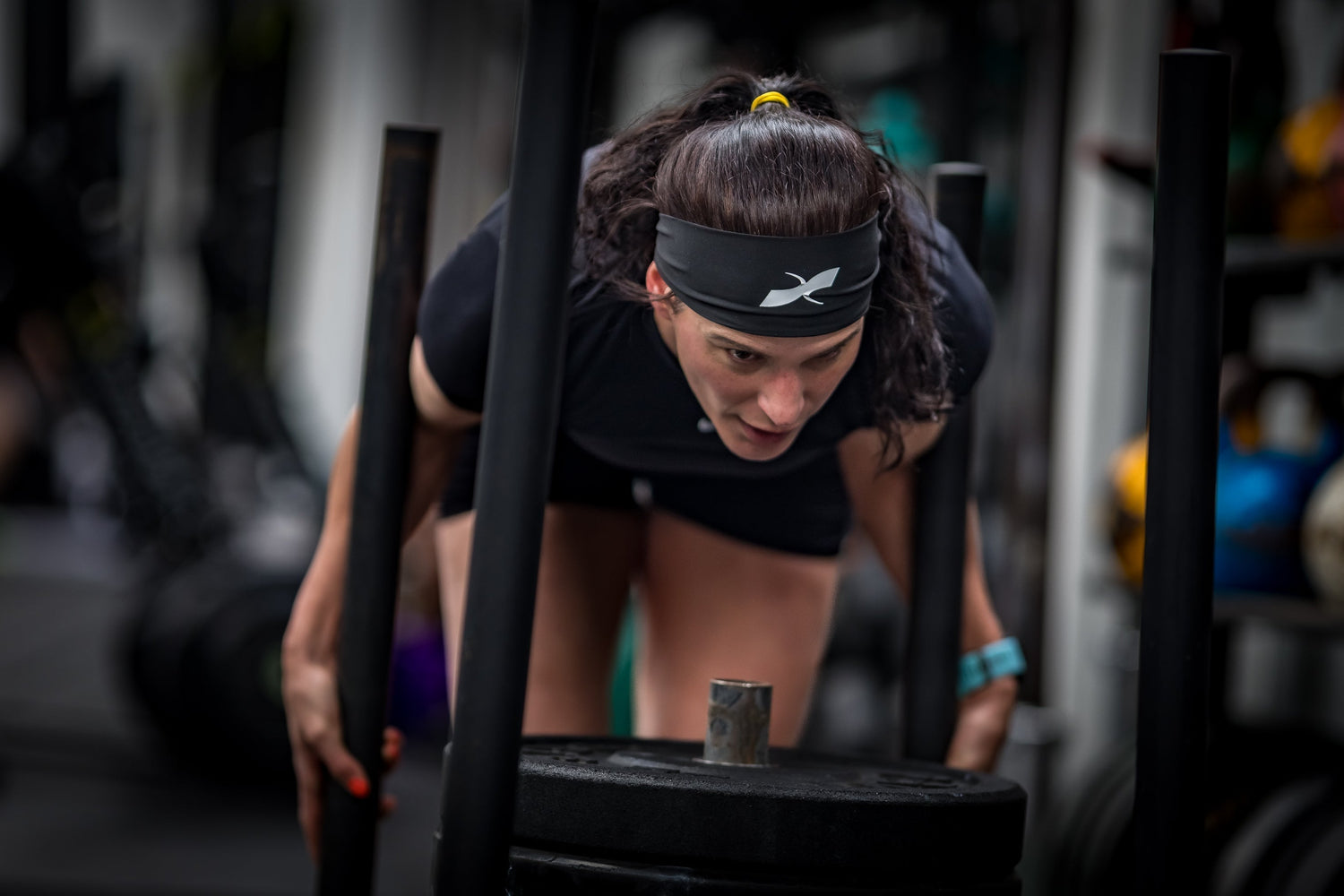 Hyrox athlete pushing sled during competition