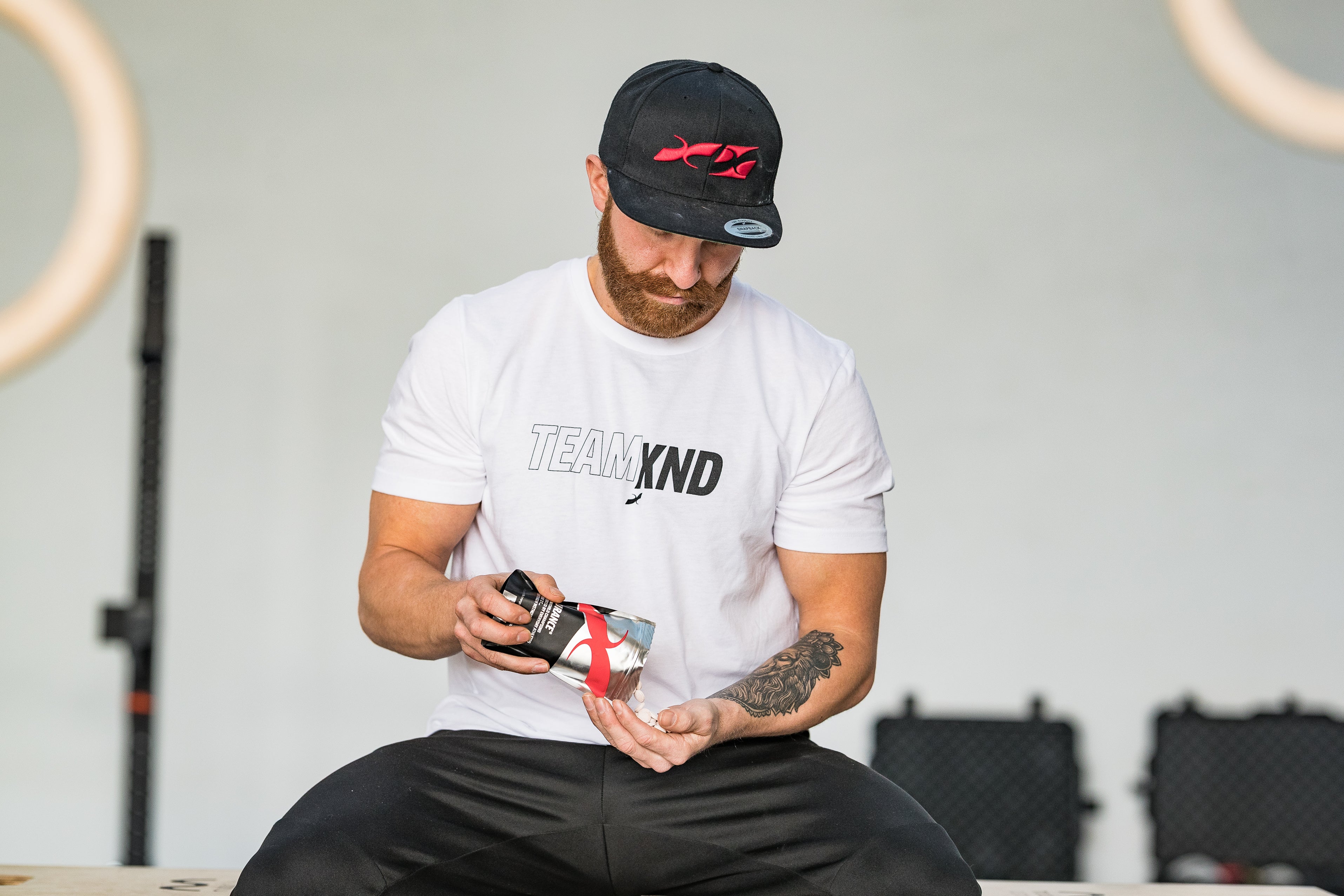 Athlete fuelling with Xendurance pre- and post-workout supplements like FUEL-5, Lactic Acid Buffer, Energy Gels, Protein, and Hydro to enhance endurance and recovery.