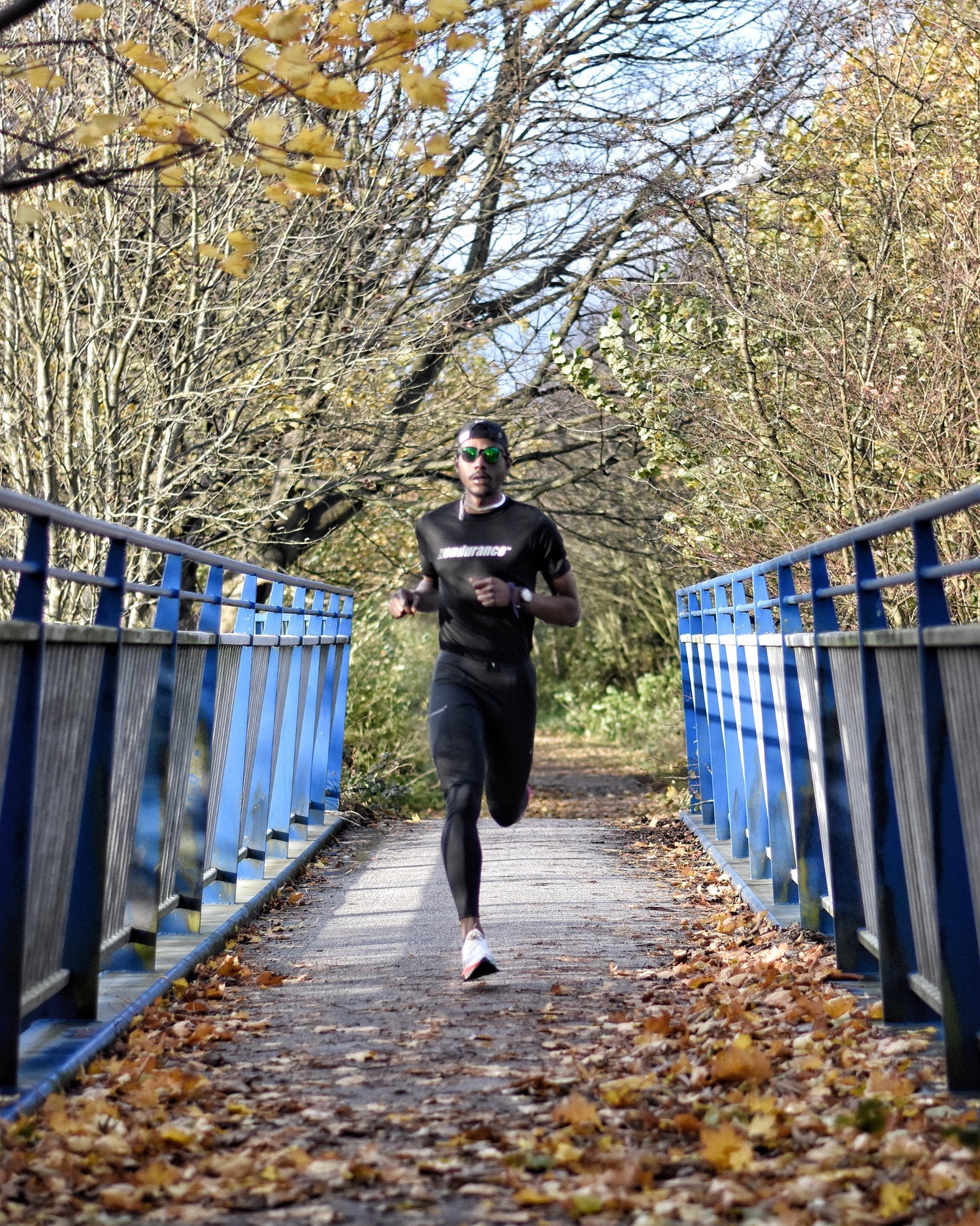 Marathon runner crossing bridge with determination and endurance.